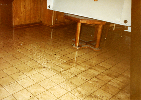 The murk the water left behind after the second 1989 flood. The ashy color of the wood at the bottom of the table reflects that it was submerged for a long time—and now ruined.